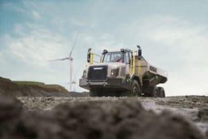 Rokbak truck in quarry with wind turbine